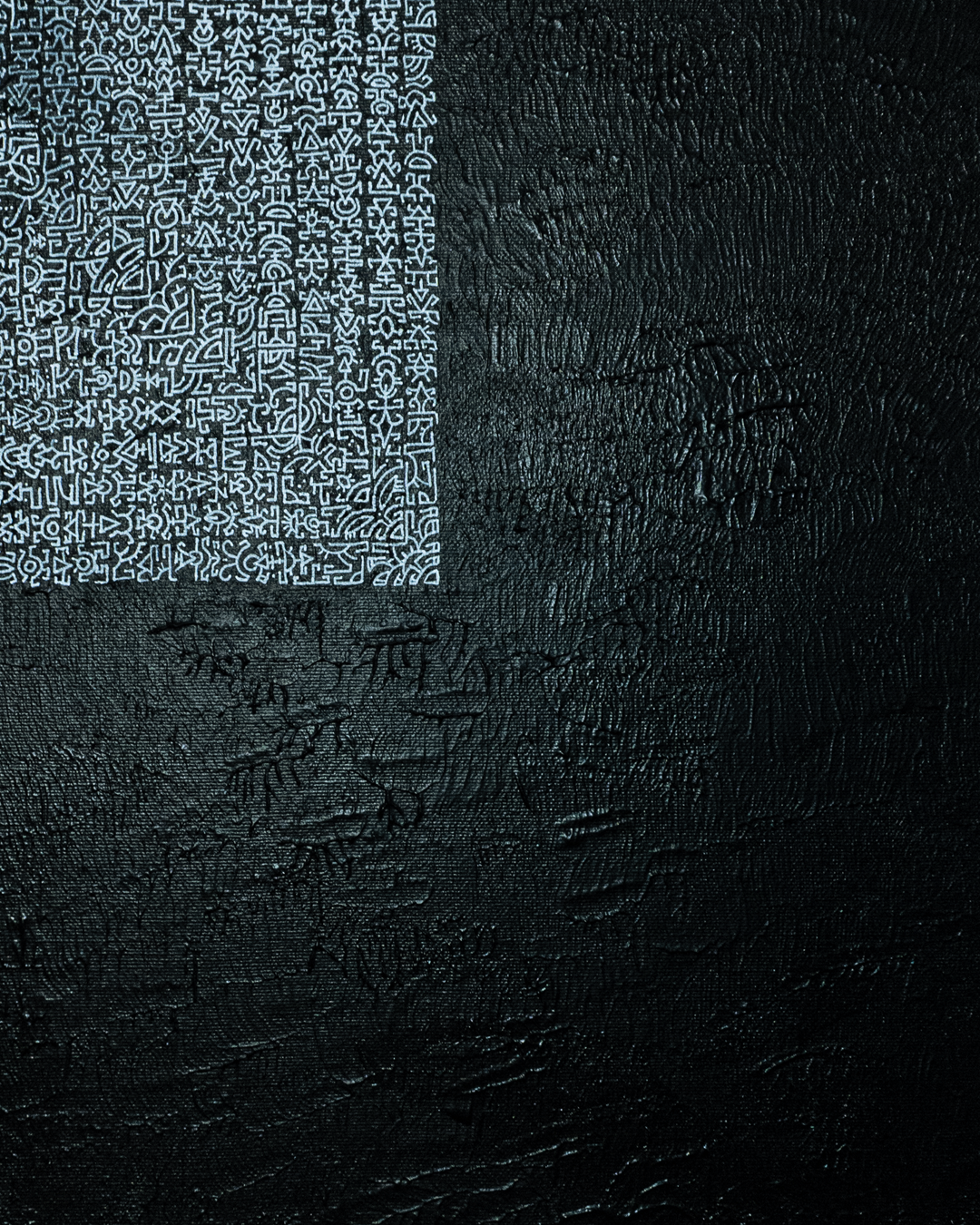 Black textured surface with a white geometric pattern on the left side