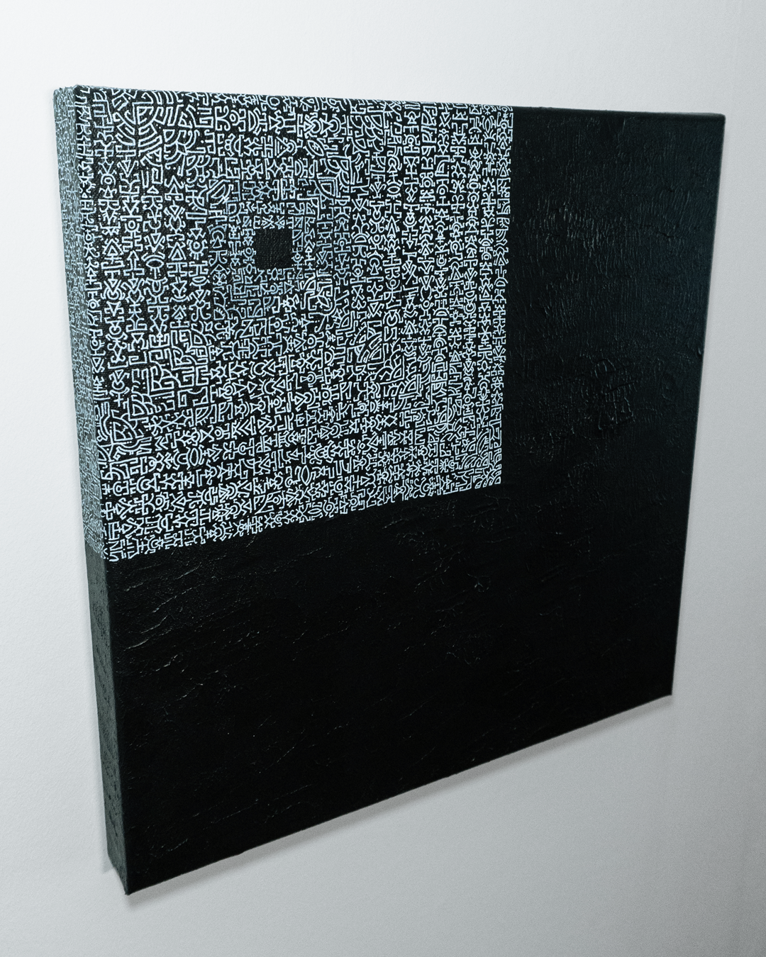 Square artwork with black and white pattern on a white background